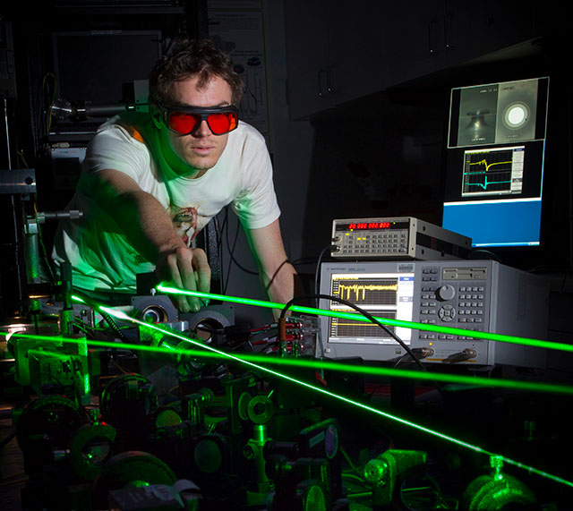a researcher works with lasers