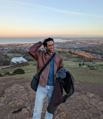 Rishi standing on a mountain at Cambridge